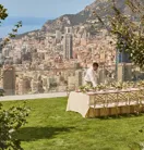 A private event setup on the lawn at Maybourne Riviera, featuring elegant décor, refined table arrangements, and open views over the Mediterranean coastline.