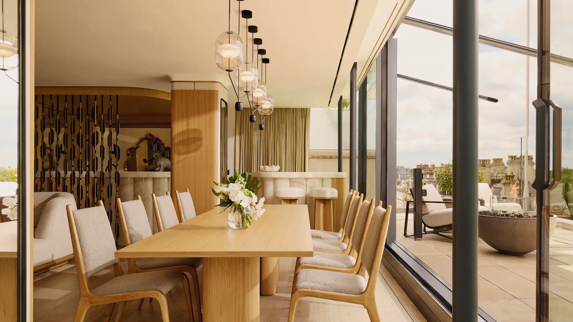 ChatGPT said:

A bright dining area with a wooden table and chairs, pendant lighting, and glass doors opening to a terrace with city views