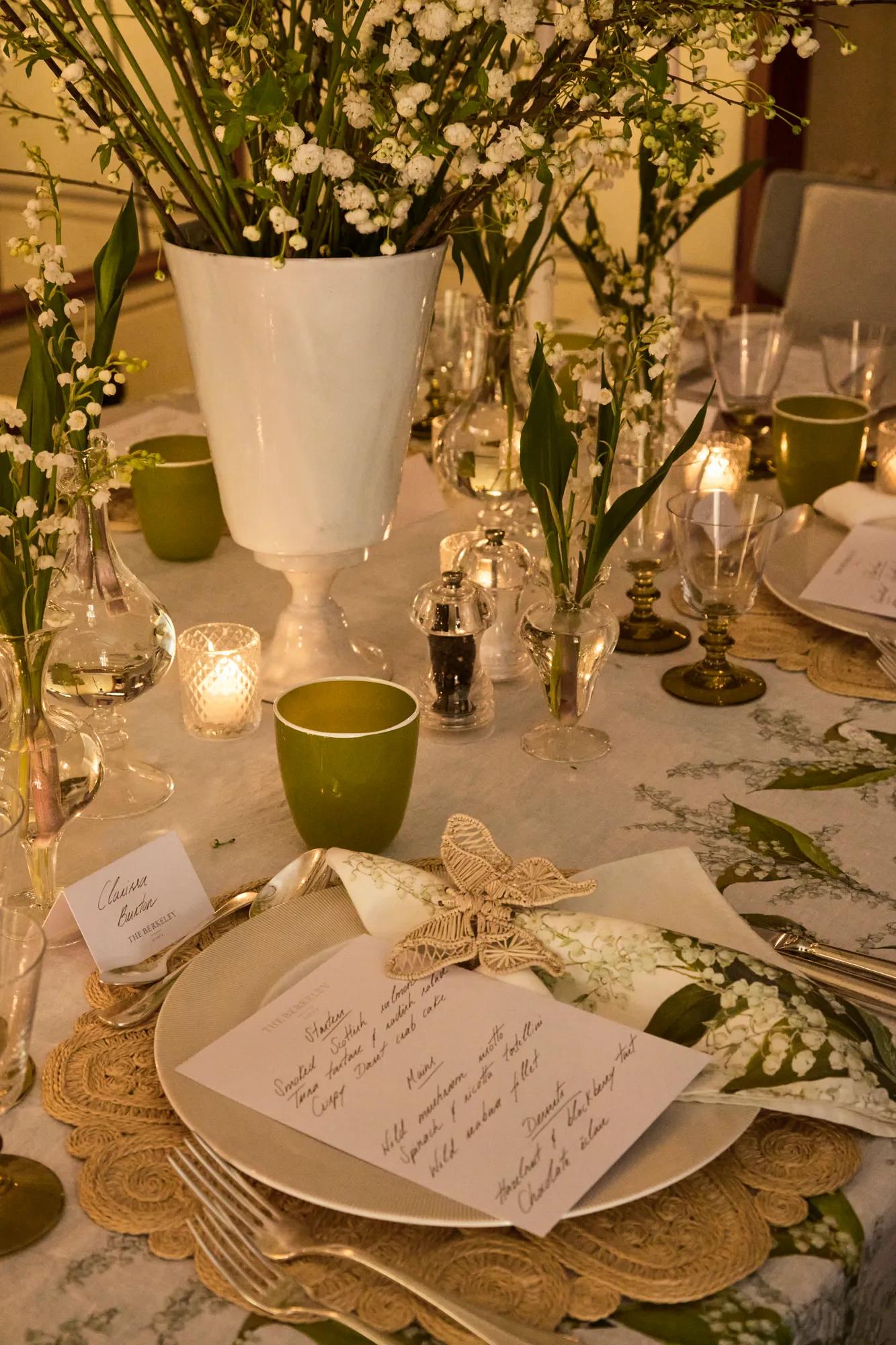 Copilot said:

Close-up of an elegant table setting with white floral arrangements, candlelight, and handwritten place cards.