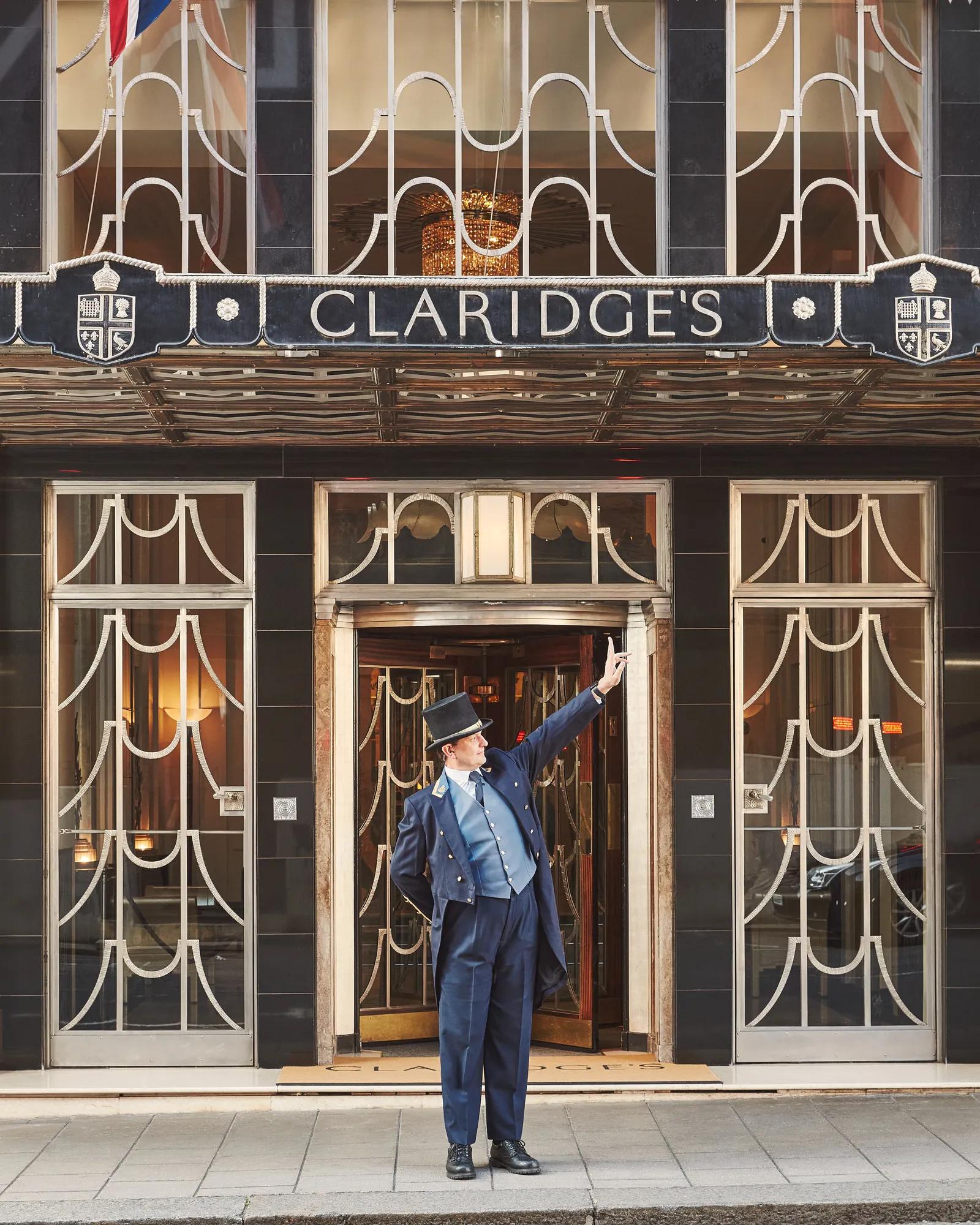The exterior of Claridge’s with a uniformed doorman standing at the entrance.