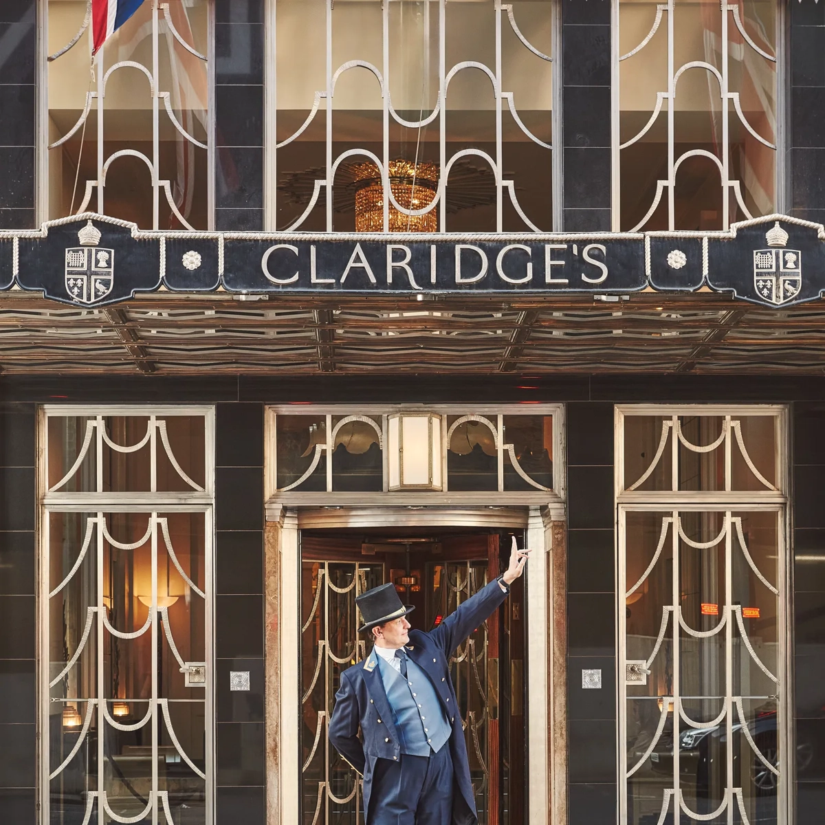 The exterior of Claridge’s with a uniformed doorman standing at the entrance.