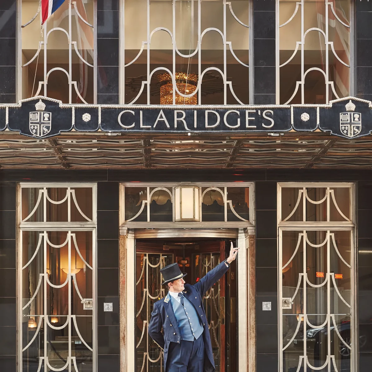 The exterior of Claridge’s with a uniformed doorman standing at the entrance.